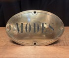 Antique brass shop sign.