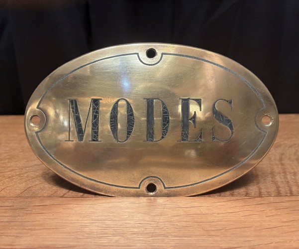 Antique brass shop sign.