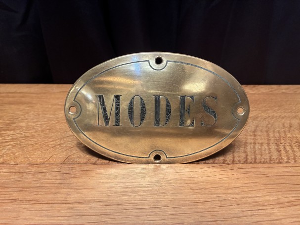 Antique brass shop sign.