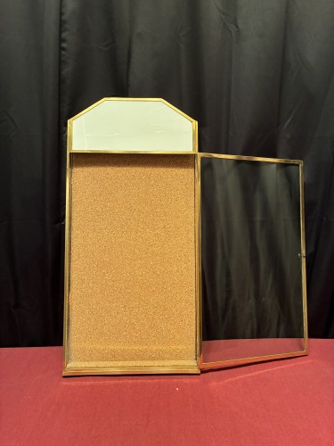 Antique wall-mounted jewelry display case.