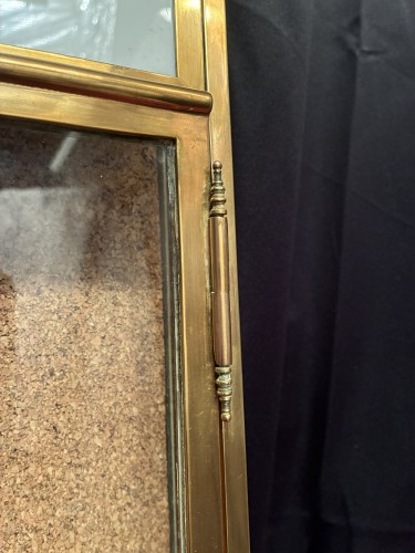 Antique wall-mounted jewelry display case.