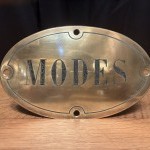 Antique brass shop sign.