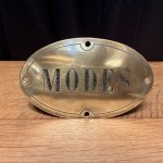 Antique brass shop sign.