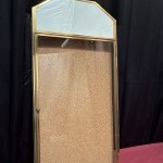 Antique wall-mounted jewelry display case.