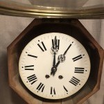 Antique wall clock from a shop or brasserie.